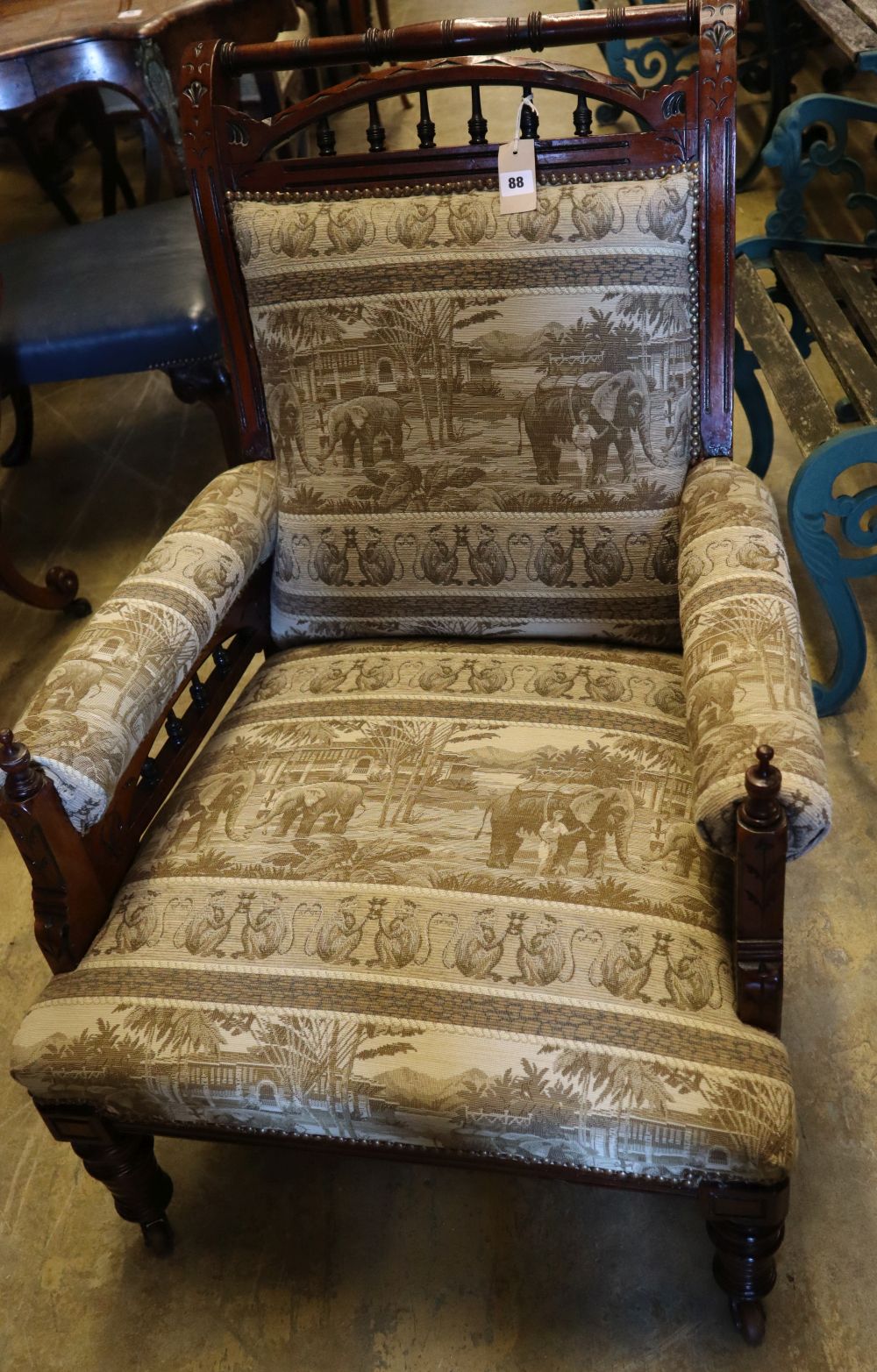 A Victorian aesthetic movement inlaid mahogany armchair, with later elephant pattern upholstery, width 68cm height 93cm